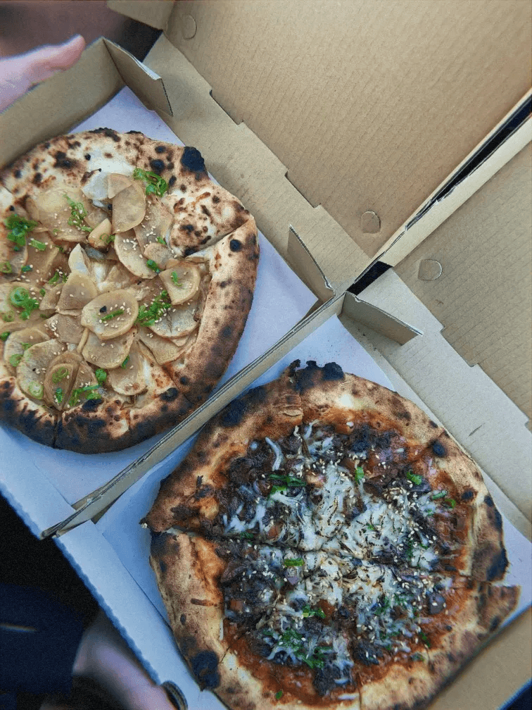 three pizzas on table